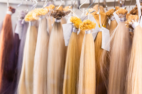 Exhibition of multicolored hair extensions in beauty salon