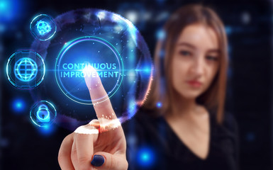 Business, Technology, Internet and network concept. Young businessman working on a virtual screen of the future and sees the inscription: Continuous improvement