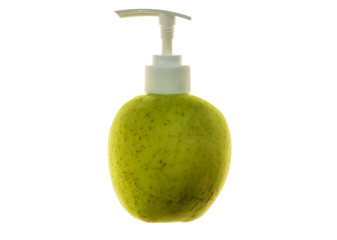 Obraz premium Green juicy apple with dispenser for soap or cosmetics on white isolated background.