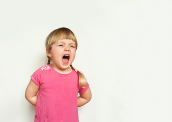 Cute blonde angry little girl screaming loudly on white background