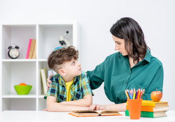 Psychologist talks to a boy at school