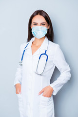 Portrait of pretty female doctor crossed hands wear medical safety sterile mask on face, pandemic corona virus prevention protection concept 2020 covid19