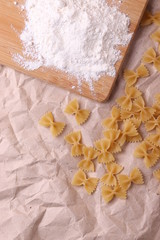 Italian Farfalle Pasta on the light beige rustic background