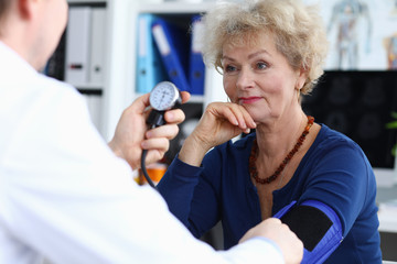 Smiling elderly lady in blue blouse