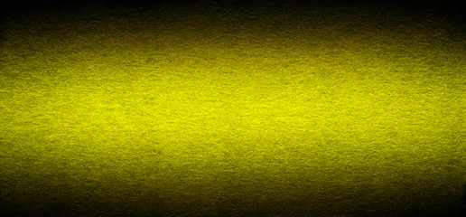 Good quality porous grunge yellow cardboard paper texture close-up with vignette dimming on the sides.