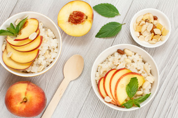 Sorghum salad with nuts and fresh peach on wooden boards.