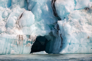 Icebergs floating. Ices and volcanic ash. Glacier lagoon. Melting ice. South coast Iceland.Volcanic ash on the arctic ice. Ice age glacier crevasse melting fast. Global warming. The edge of a glacier