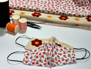 Homemade protective mask and pieces of cloth on white background. protective mask for protecting...