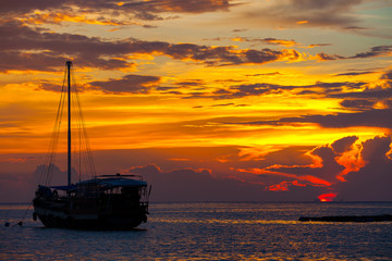 Fototapeta na wymiar View of boat silhouette with sunset light take photo from Phangan island, Thailand