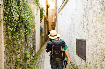 Fototapeta premium Girl walking a narrow alley