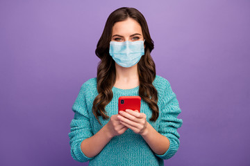 Portrait of her she nice attractive healthy wavy-haired girl wearing mask using device browsing media news sars cov air pollution isolated bright vivid shine vibrant violet color background