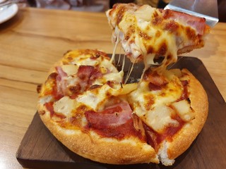 Pizza on a wooden mat