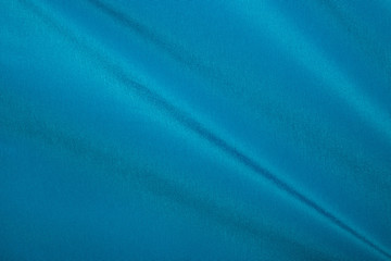 Crumpled blue fabric texture as background