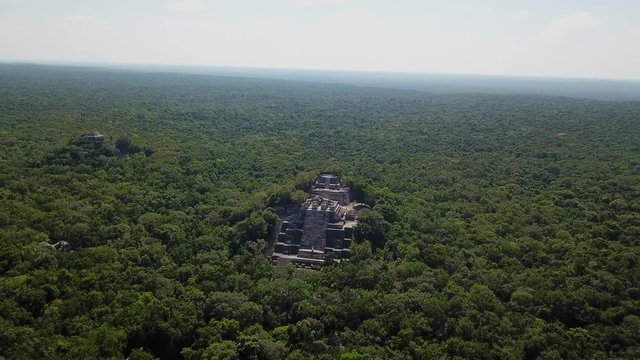 Aerial video flying towards the mayan Calakmul Temple in the Mexican Yucatan. The mayan ruins at Calakmul, Mexico