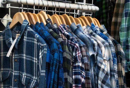 Blue flannel shirts in thrift store filling page for a material texture 