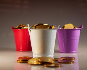 three buckets filled with golden coins. © APHOTOSTUDIO