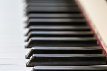 Close-up with shallow DOF of piano keyboard. Digital piano keys playing music.