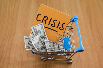 dollars in a shopping cart and a sticker with the words 