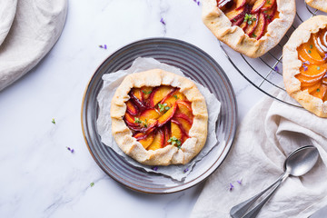 Homemade seasonal summer fruit galette, tart, pie with nectarines, peaches