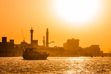 Fototapeta premium Old Dubai Traditional Abra boat ride , beautiful sunset view of old Dubai