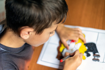 Boy, drawing at home, doing his homework