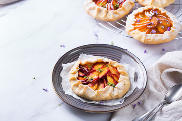 Homemade seasonal summer fruit galette, tart, pie with nectarines, peaches
