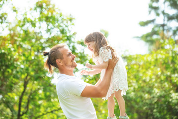 Fototapeta premium Happy beautiful family together father and daughter portrait on a walk on a Sunny summer day