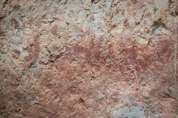 Ancient paintings painted by prehistoric people on the cliffs showing various stories of that era.