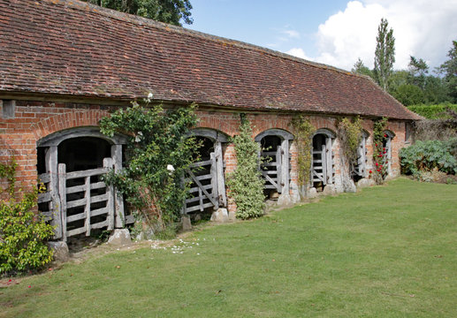 View of the outside of a renovated stable block at an English country garden.