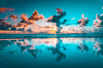 Fototapeta na wymiar Fantastic beach sunset view colorful cloudy sky and calm sea, beautiful beach background