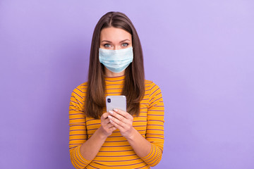 Close-up portrait of her she nice attractive charming healthy girl wear gauze mask using device...