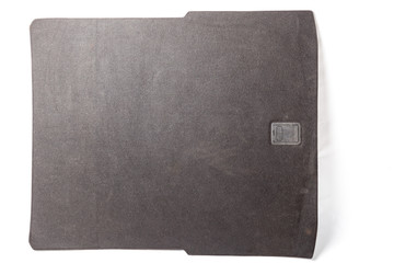 Fabric lining of the trunk floor of a gray car with a plastic clip as a separate part on a white...