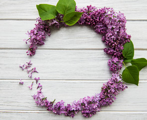 Frame of branches and flowers of lilac in the shape of a circle