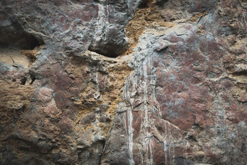 Ancient paintings painted by prehistoric people on the cliffs showing various stories of that era.
