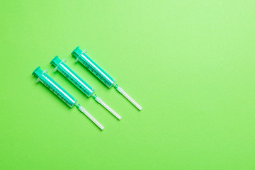 Top view of syringes in a row for medical injection on colorful background with copy space. Health and vaccination concept