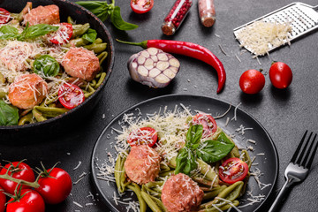 Delicious fresh pasta with meatballs, sauce, cherry tomatoes and basil