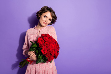 Portrait of nice-looking attractive lovely cute pretty charming feminine cheerful dreamy girl holding in hands roses romance isolated on bright vivid shine vibrant lilac violet purple color background