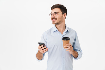 Photo of happy caucasian man drinking coffee and using cellphone