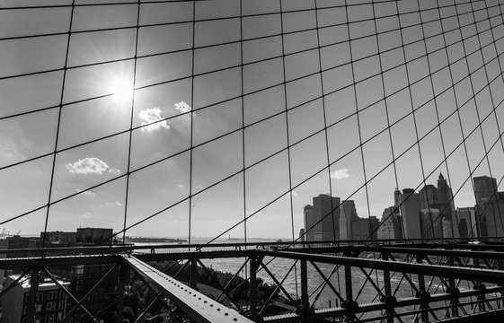 Fototapeta New York City, USA - October 18, 2016: View of downtown Manhattan as seen through the suspension cables of Brooklyn Bridge