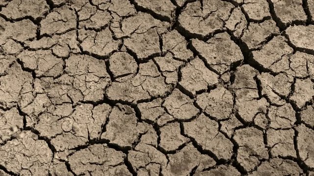 Drought cracked soils, dry crack lakes, drought soil at the bottom of the river. Ecosystems caused by climate change. Drought concept. thirst and desertification. tilting bak view. top angle  top view