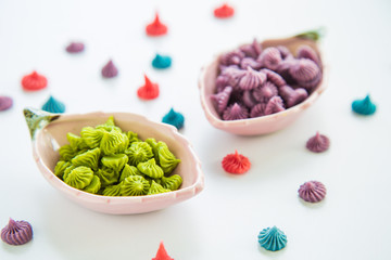 Close up A-lua or Allure Thai handmade candy in mini bowl on white destop. A-lua or Allure is traditional Thai desserts sweet.