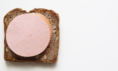 A typical Russian sandwich made from black rye bread with sunflower seeds and traditional Russian sausage. Simple food for poor people.