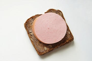 A typical Russian sandwich made from black rye bread with sunflower seeds and traditional Russian sausage. Simple food for poor people.