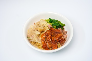 Roasted duck with eggs noodles and dumplings  with vegetables isolated on white background.  Famous and delicious food in Thailand and Asia.