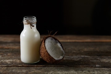 Ripe half cut coconut on a wooden background. Ripe half cut coconut on a wooden background. Coconut cream and oil.
