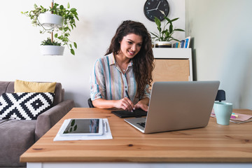 Graphic designer woman hands on retouching pad and laptop computer stock photo