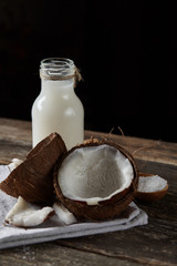 Ripe half cut coconut on a wooden background. Ripe half cut coconut on a wooden background. Coconut cream and oil.