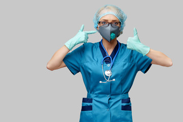 female doctor with stethoscope wearing protective mask and latex gloves over light grey background