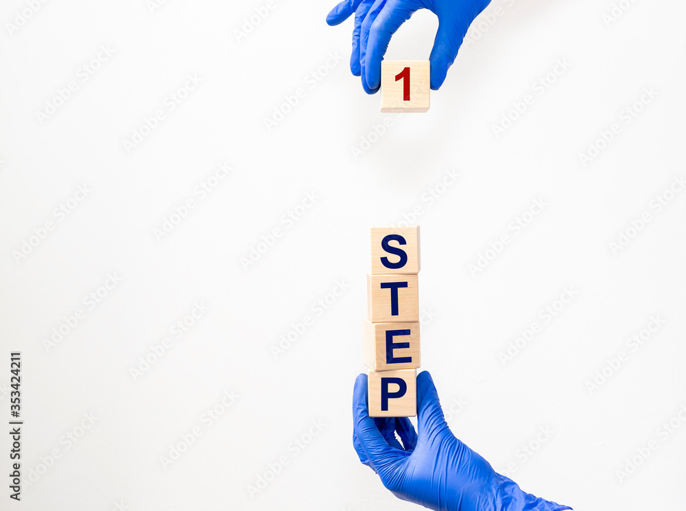 Poster step by step concept. step 1 one text on wooden cube blocks on blue grey table