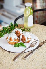 A traditional French savory choux dough cheese puff filled with fresh cheese mixed with smoked salmon in a plate decoration with dill leaf. A gourmet meal for the holiday table. Vertical photo